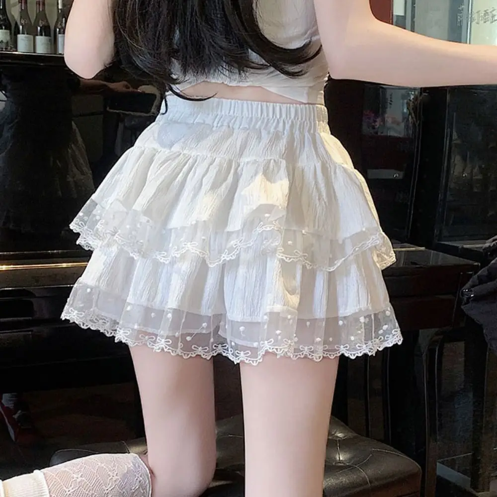 Gonna torta gonfia a pois carini Gonna corta da donna a vita alta con fiocco in pizzo dolce Gonna corta a trapezio con volant multistrato Festa