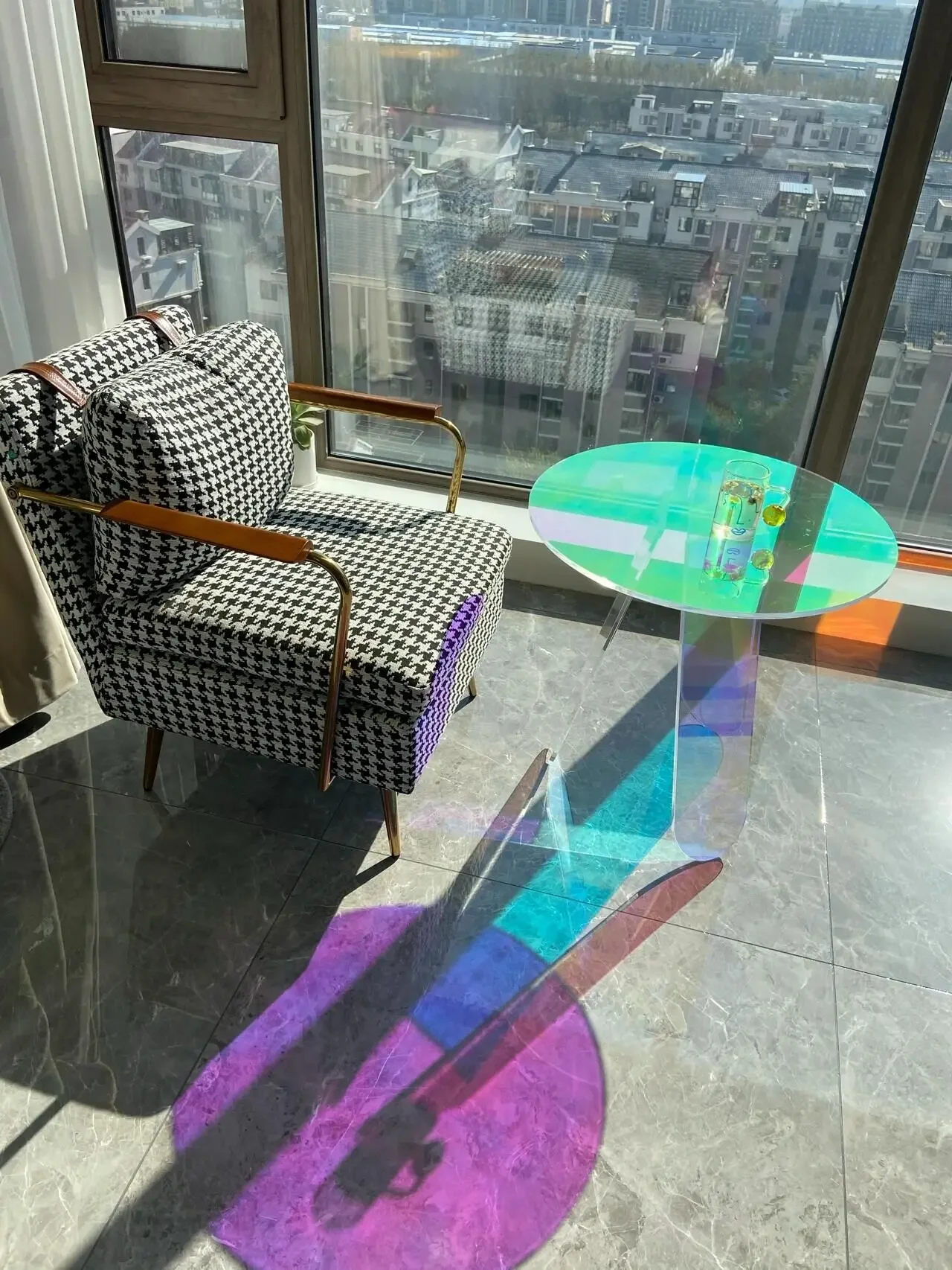 Rainbow coffee table next to the glass side sofa