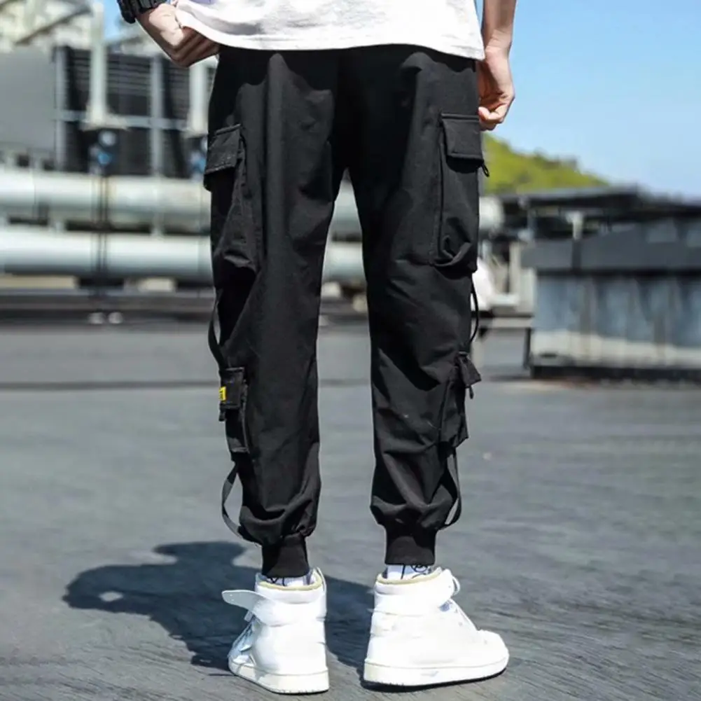 

Reinforced Pocket Pants Men's Loose Fit Cargo Pants with Ankle-banded Drawstring Waist Multiple Pockets Strap Decor for Fitness