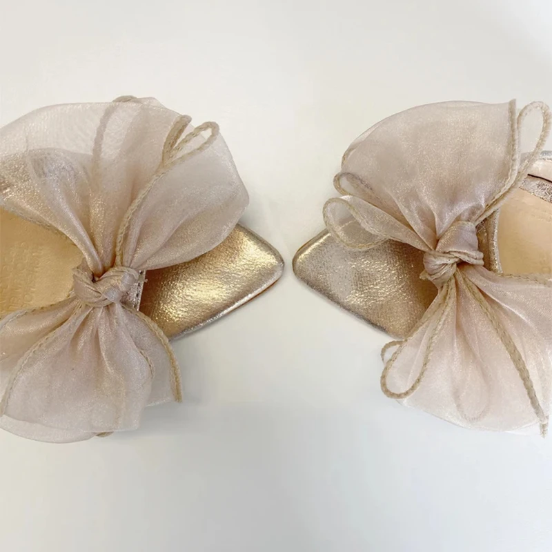 

Bow Pointed Mules features an oversized and an upper finished in a soft shimmering champagne tone Dress Heel Slippers