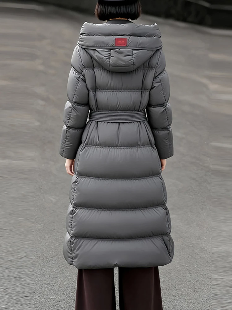 Elegant Long down jacket with hooded women's 2026 Winter High quality warm puffer coat with sashes Female outwear INKEO DJ640