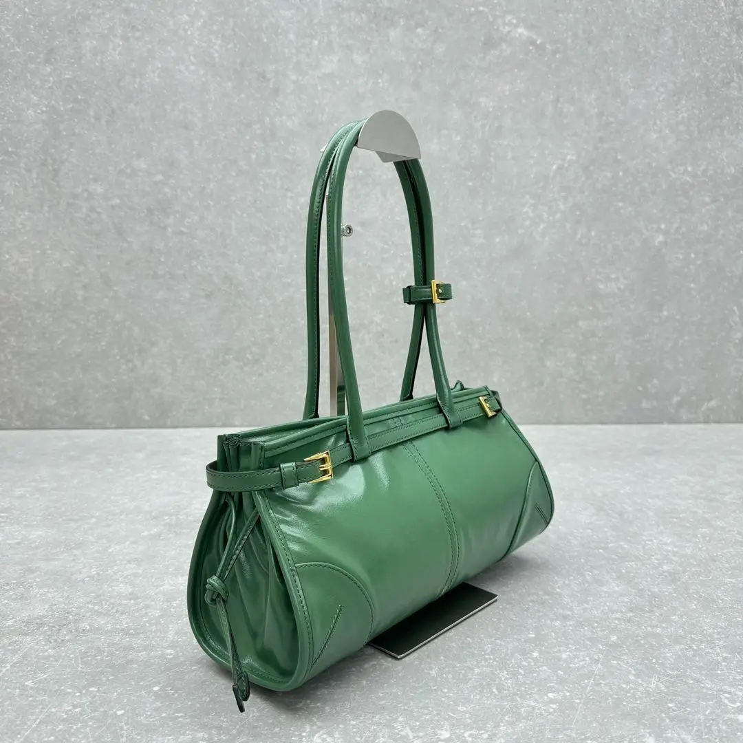 

Bright green smooth leather shoulder bag with an adjustable top handle, removable crossbody strap, and gold hardware.