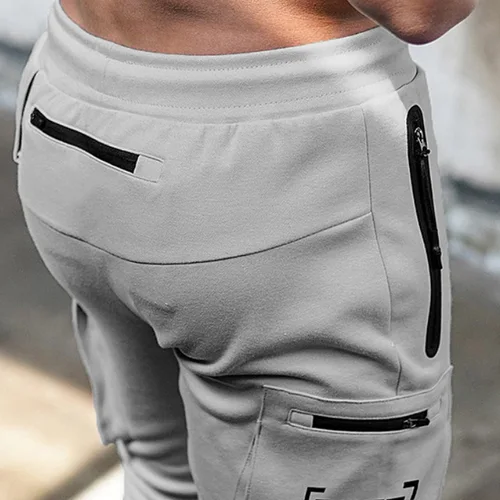Imagen 2 del producto Pantalones de entrenamiento con múltiples bolsillos para gimnasio y Fitness para hombre, pantalones de chándal de algodón para correr, pantalones de entrenamiento de moda de camuflaje para hombre