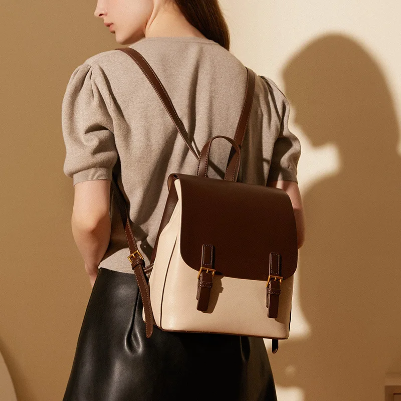 

Real leather double-shoulder small backpack contrasting color flip-top lock and lightweight, water-resistant women's travel bag