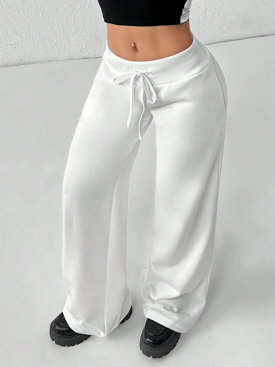 

Женские белые трикотажные спортивные брюки с низкой посадкой, широкими штанинами и завязками на талии