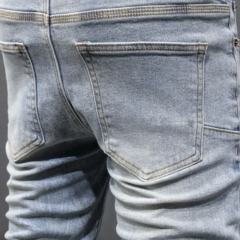Fashionable new men's light blue jeans, washed, nostalgic, perforated, white patch, elastic, slim fit, painted jeans, hip-hop br