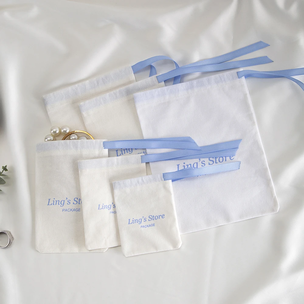 100Pcs Custom Logo White Cotton Jewelry Muslin Bag Canvas Ribbon Pouch For Ring Earrings Watch Sunglasses Headset Gift Organizer view 6