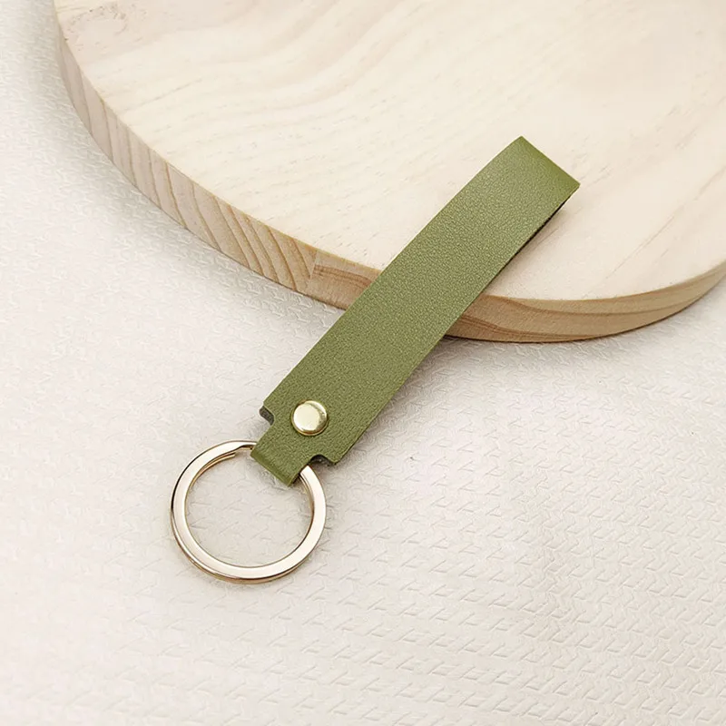 Versatile Solid Leather Key Buckle Handle rope bag Pendant Doll Portable strap Fashionable Couple car Keychain Accessories