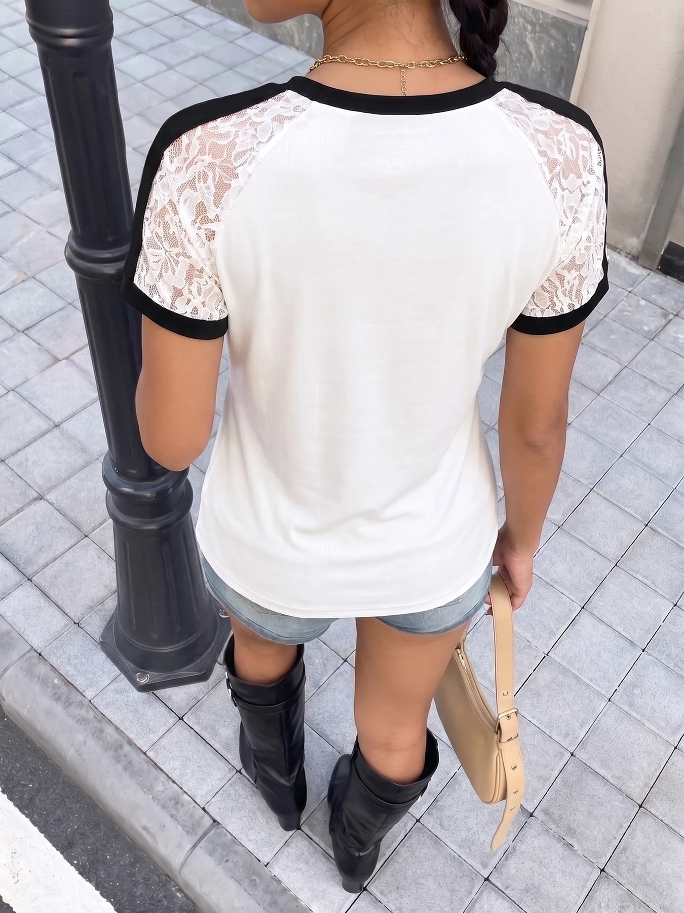 Women's white short-sleeved T-shirt with lace trim on the sleeves and embroidered cross pattern.