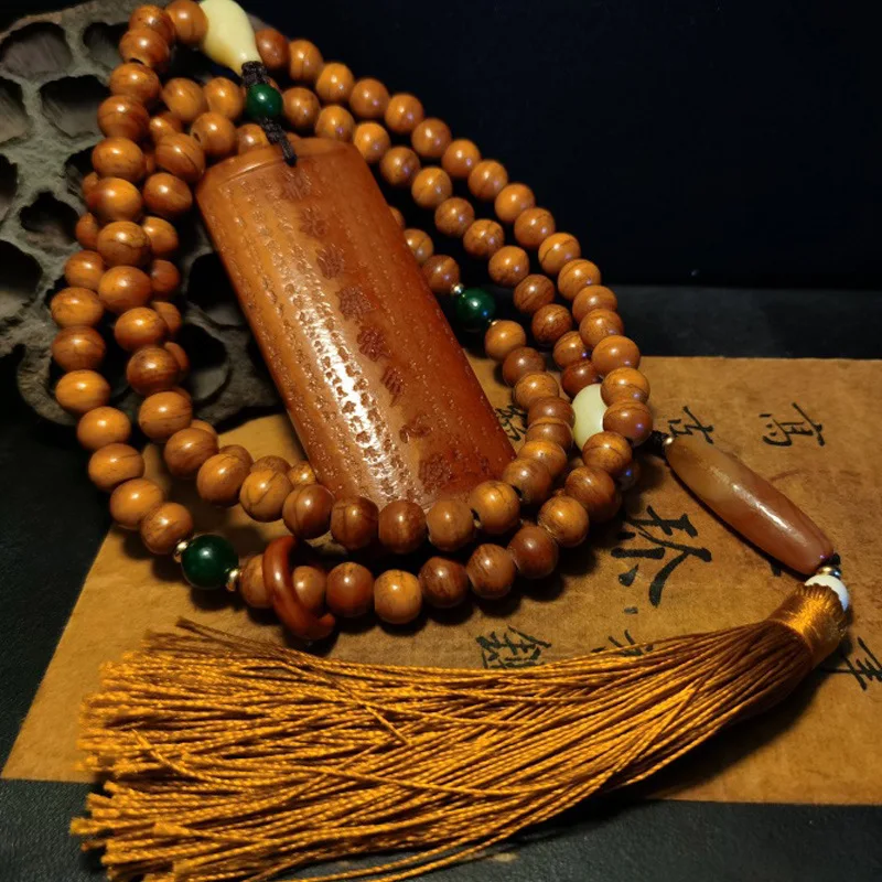 Tibetan-style beaded bracelet made of weathered textured and camel bones featuring 108 smooth oily cow bone beads