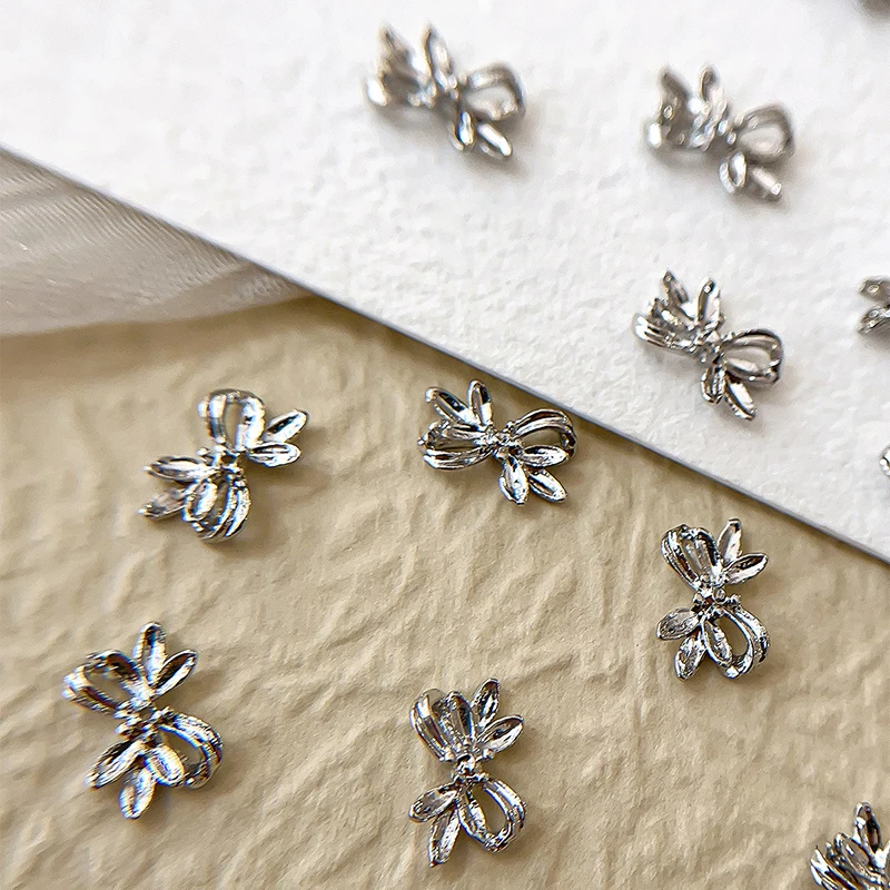20 piezas de aleación de plata con lazo para uñas, cinta de lujo, alas de mariposa, diamantes de imitación de Metal para decoración de uñas, accesorios de manicura