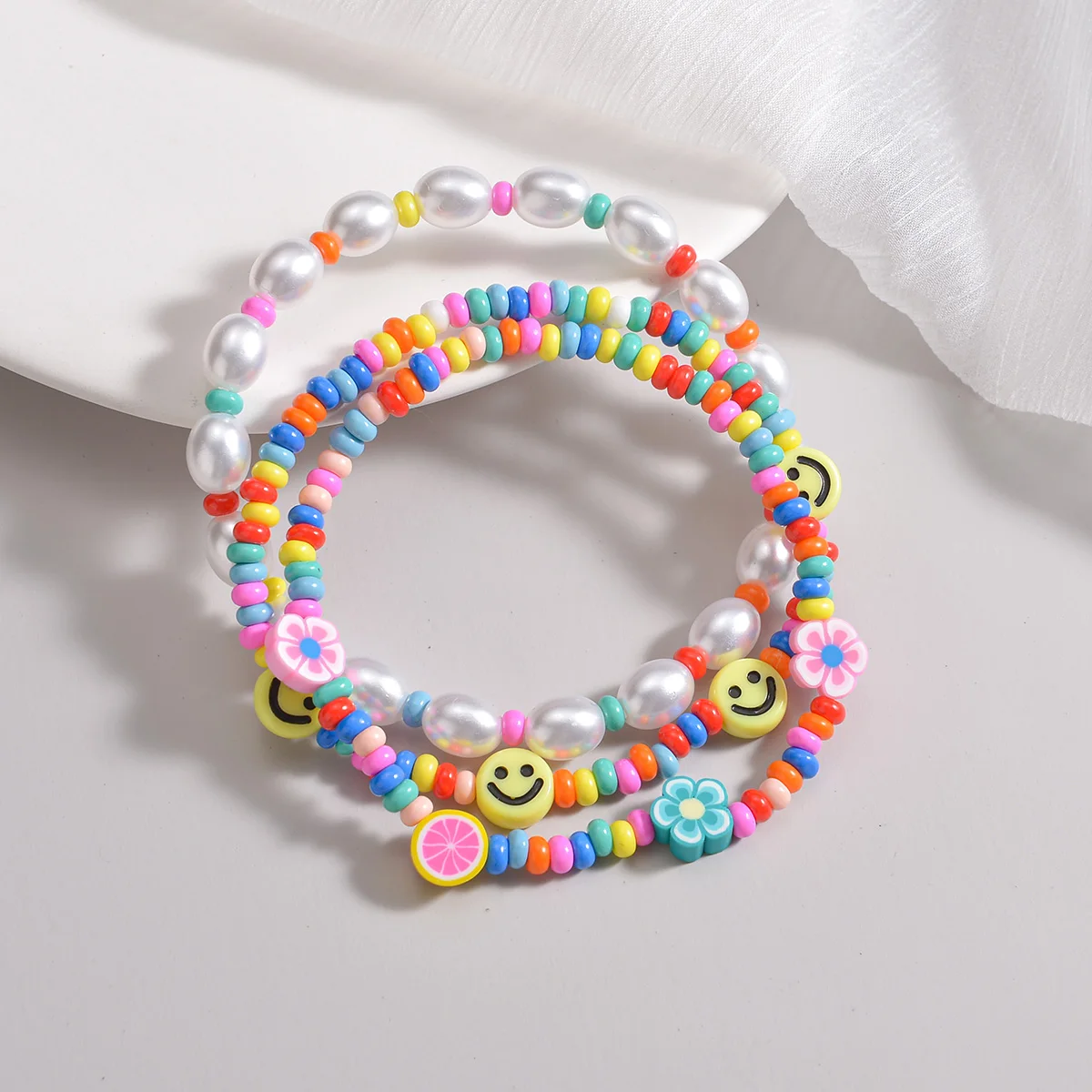 3-piece set of Bohemian style colorful rice beads mixed with smiling face pearls, multiple layered women\'s anklets
