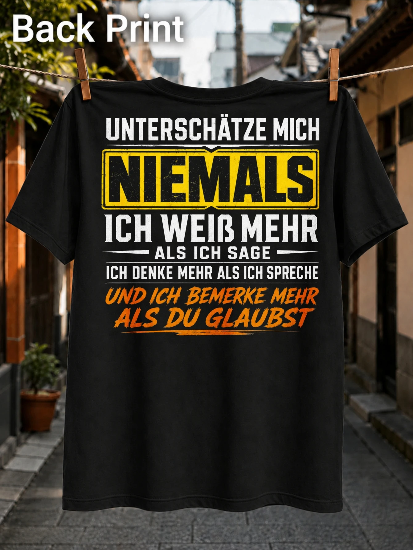 Never Underestimate Me stacked German quote with yellow warning block and orange brush text  Unisex All T-Shirt