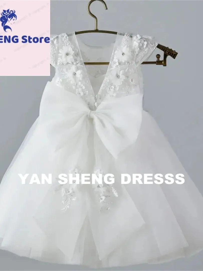فستان فتاة الزهور من التول الأبيض مخصص مع فيونكة مزينة بدون أكمام لحفلات الزفاف وأعياد الميلاد وحفلات التواصل المقدس للفتيات