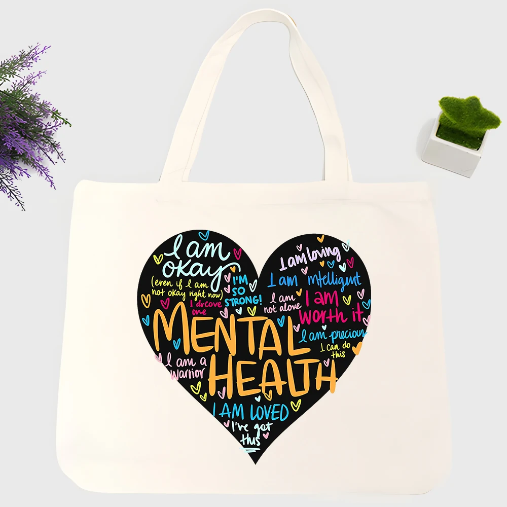 Women's heart-shaped typography print canvas tote bag, casual style for daily shopping and mental health awareness support