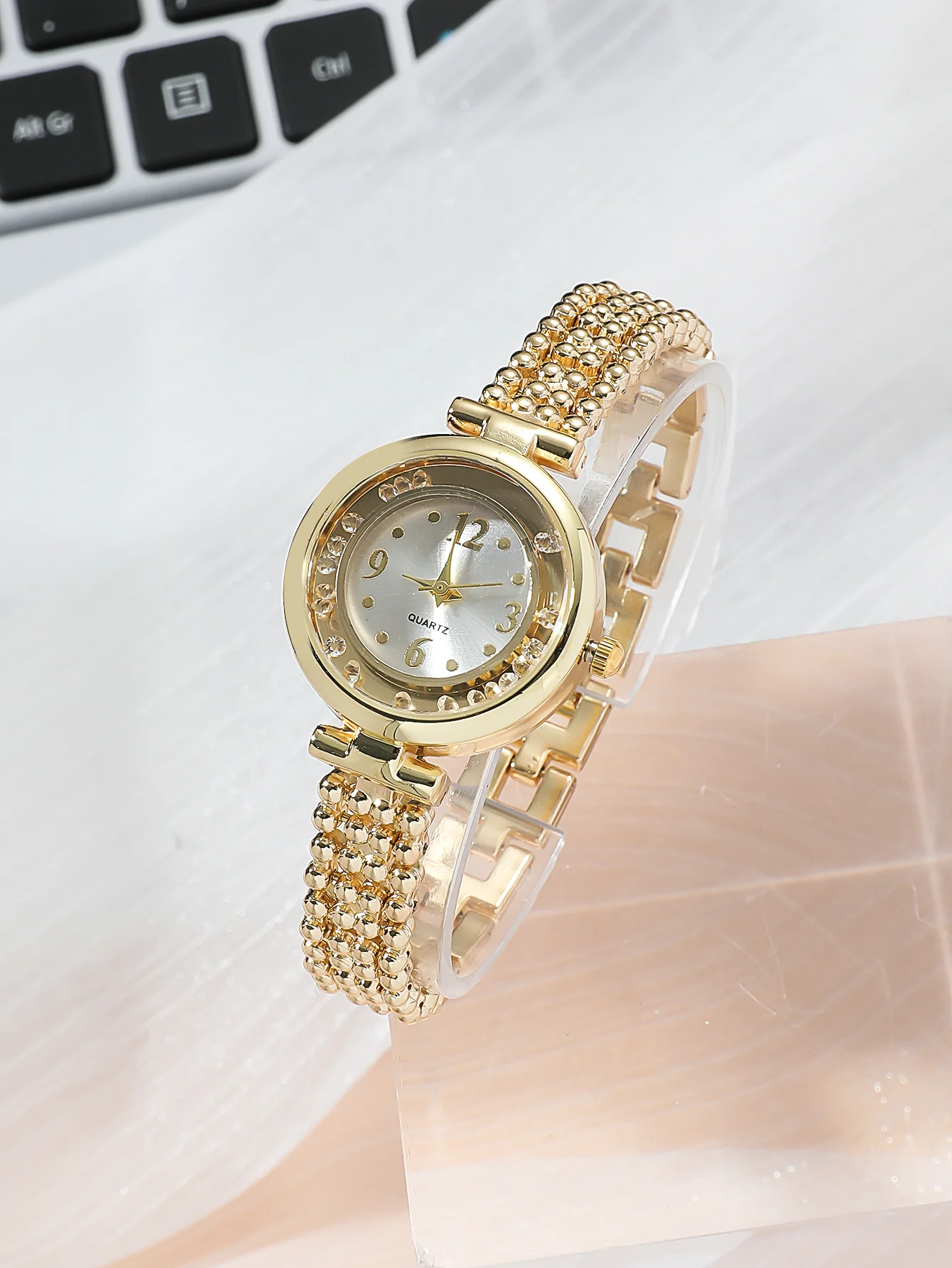 A Gold Women\'s Classic Fashion Quartz Watch With A Ball Bracelet And A Rhinestone Plum Bracelet. Can Be Used For Daily Wear