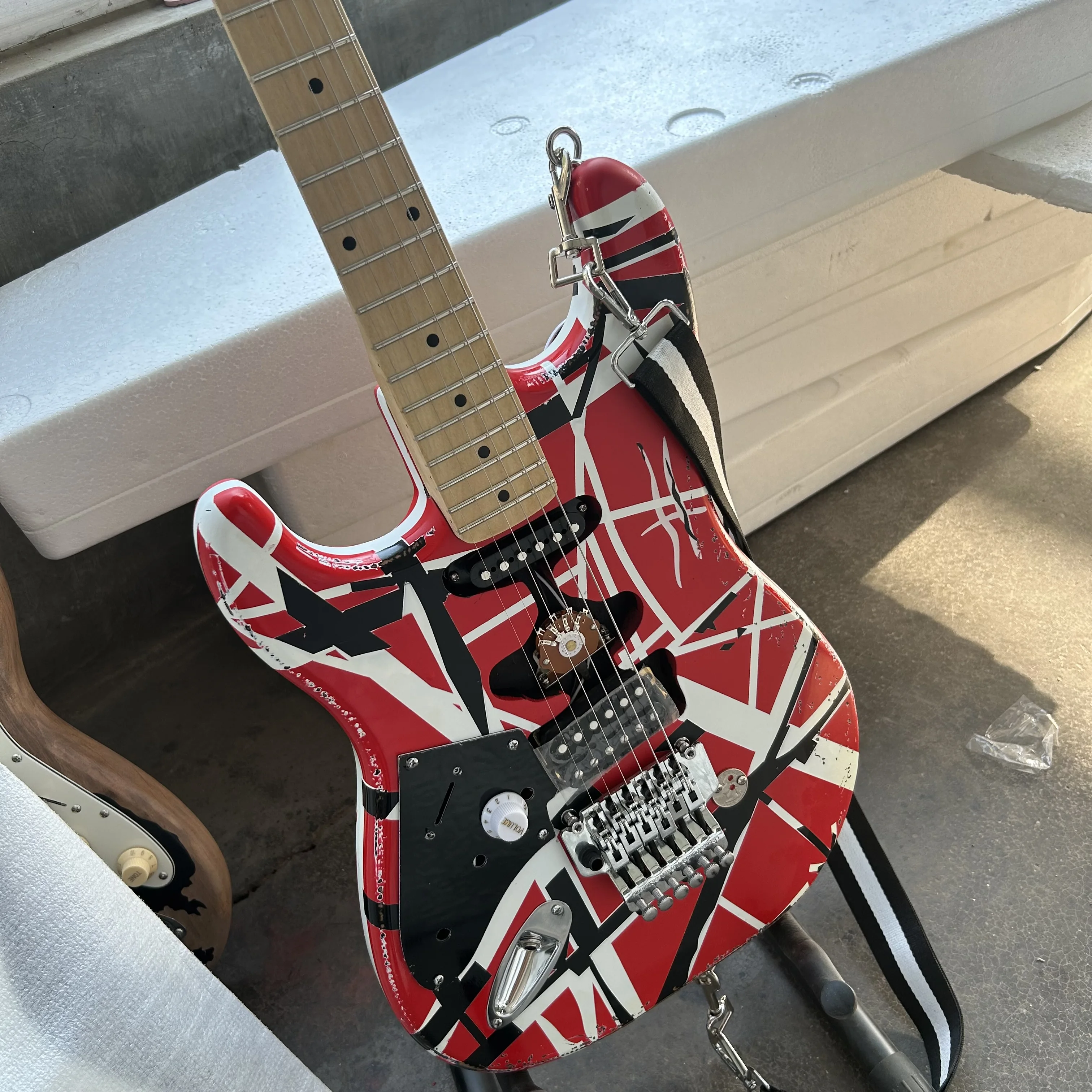 Left hand Edward Eddie Van Halen heavy cultural object red Franken electric guitar black and white stripes Freud rose Tremolo