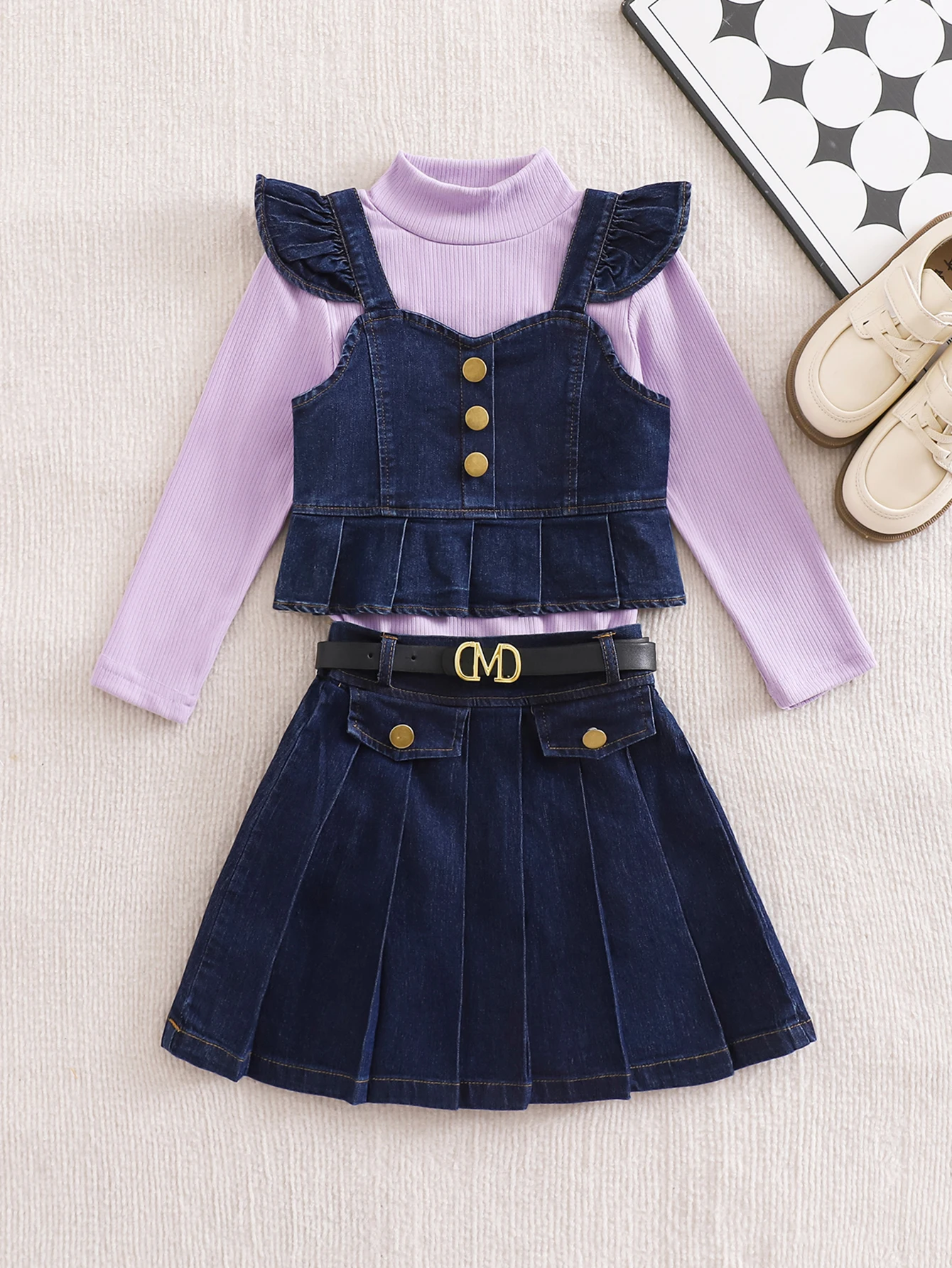 

Fashionable girl’s casual denim tunic-skirt set, including a candy-colored long-sleeved top with a belt.