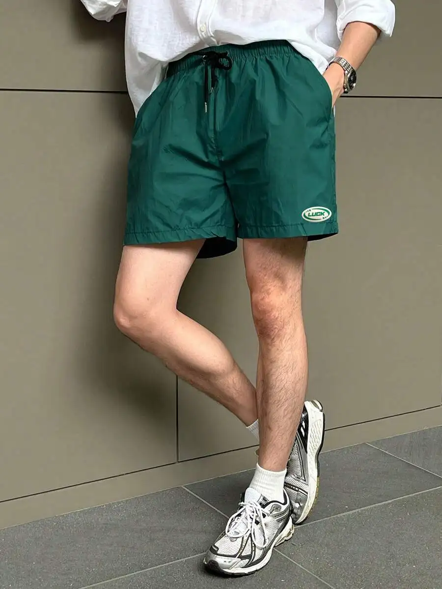 

Men Solid Green Shorts With Drawstring Waist And Embroidered Logo Detail