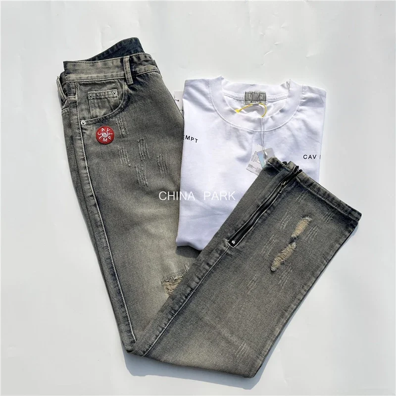 

23SS Top Quality Hole CAVEMPT C.E Jeans Men Women Niche Washed Zipper Cav Empt Jeans Trouser