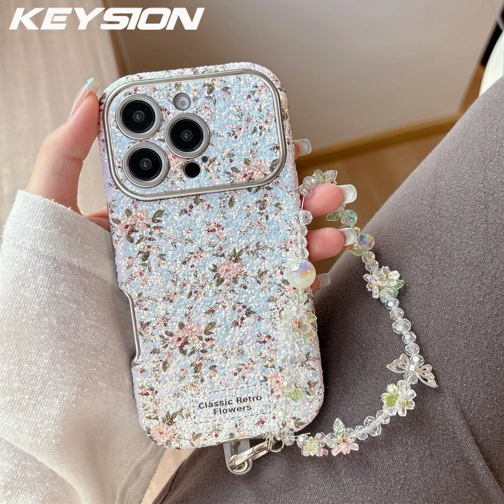 

KEYSION женский чехол для телефона с цветочным рисунком для девочек для iPhone 14, 15, 16, 17 Pro Max, противоударный чехол с закругленными краями и цепочкой-браслетом из бисера