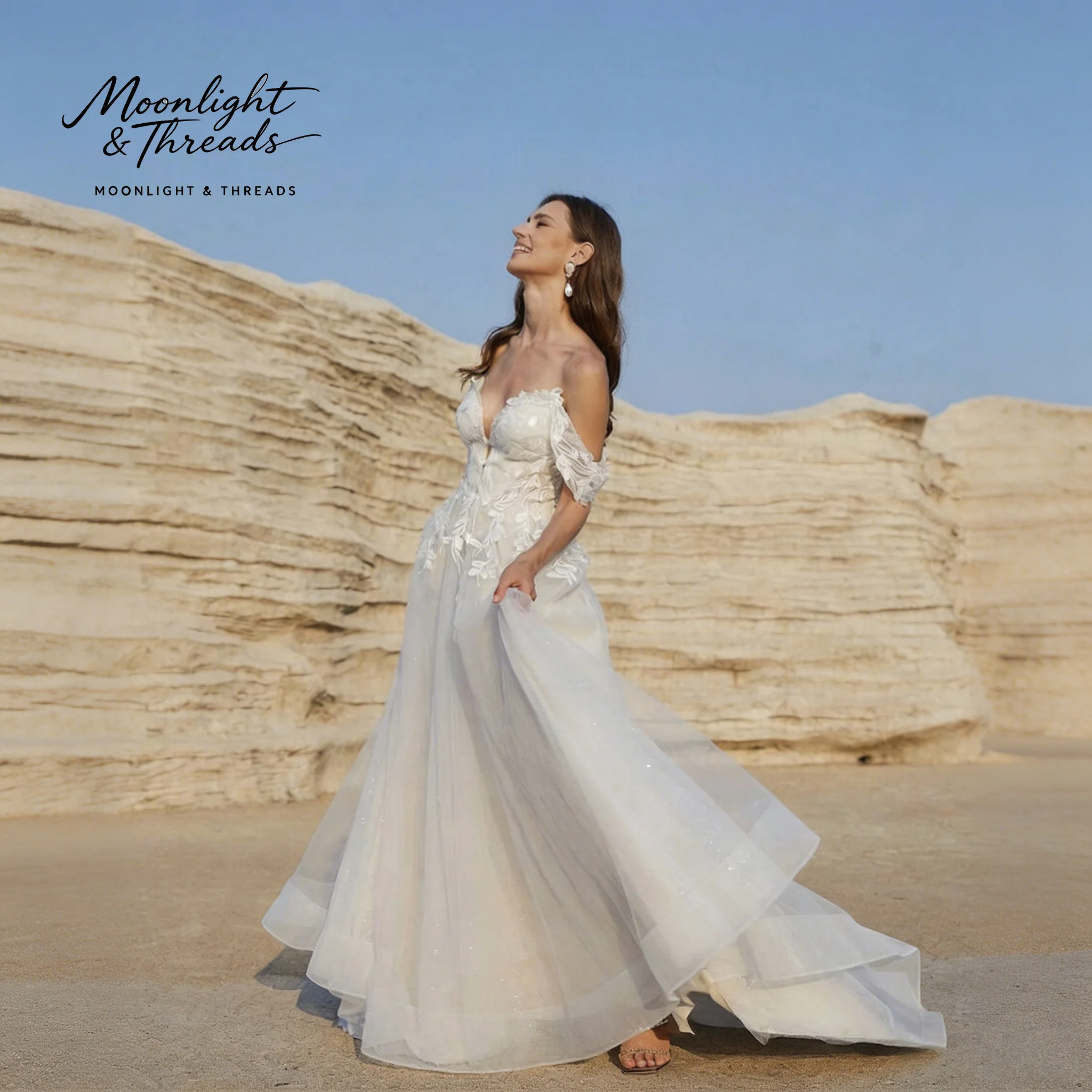 White lace off-shoulder A-line floor-length formal wedding dress with appliqué embroidery and a backless design.