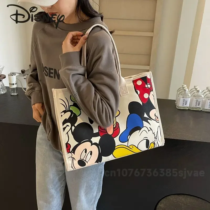 Disney Mickey 2025 กระเป๋าถือสตรีใหม่คุณภาพสูงกระเป๋าสะพายสตรีการ์ตูนผ้าใบขนาดใหญ่กระเป๋าสตรี