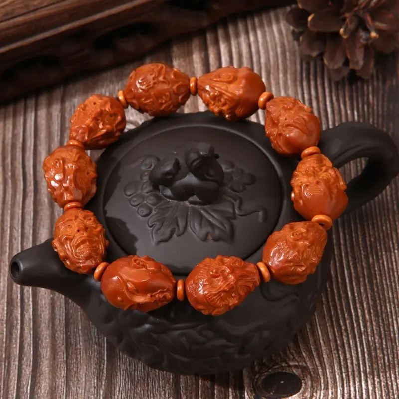 Hand-carved olive pit bracelet featuring Eighteen Arhats the God of Wealth, a handcrafted art piece for men and women to
