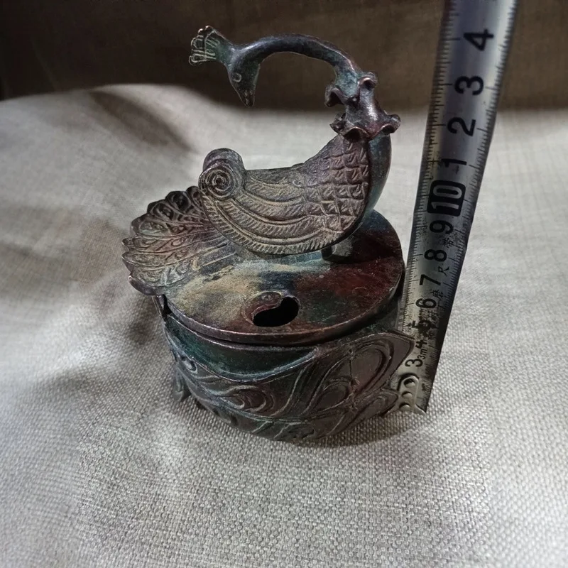Antique Artifacts: Bronze Incense Burner with Red Spots and Green Embellishments in the Shape of a Phoenix