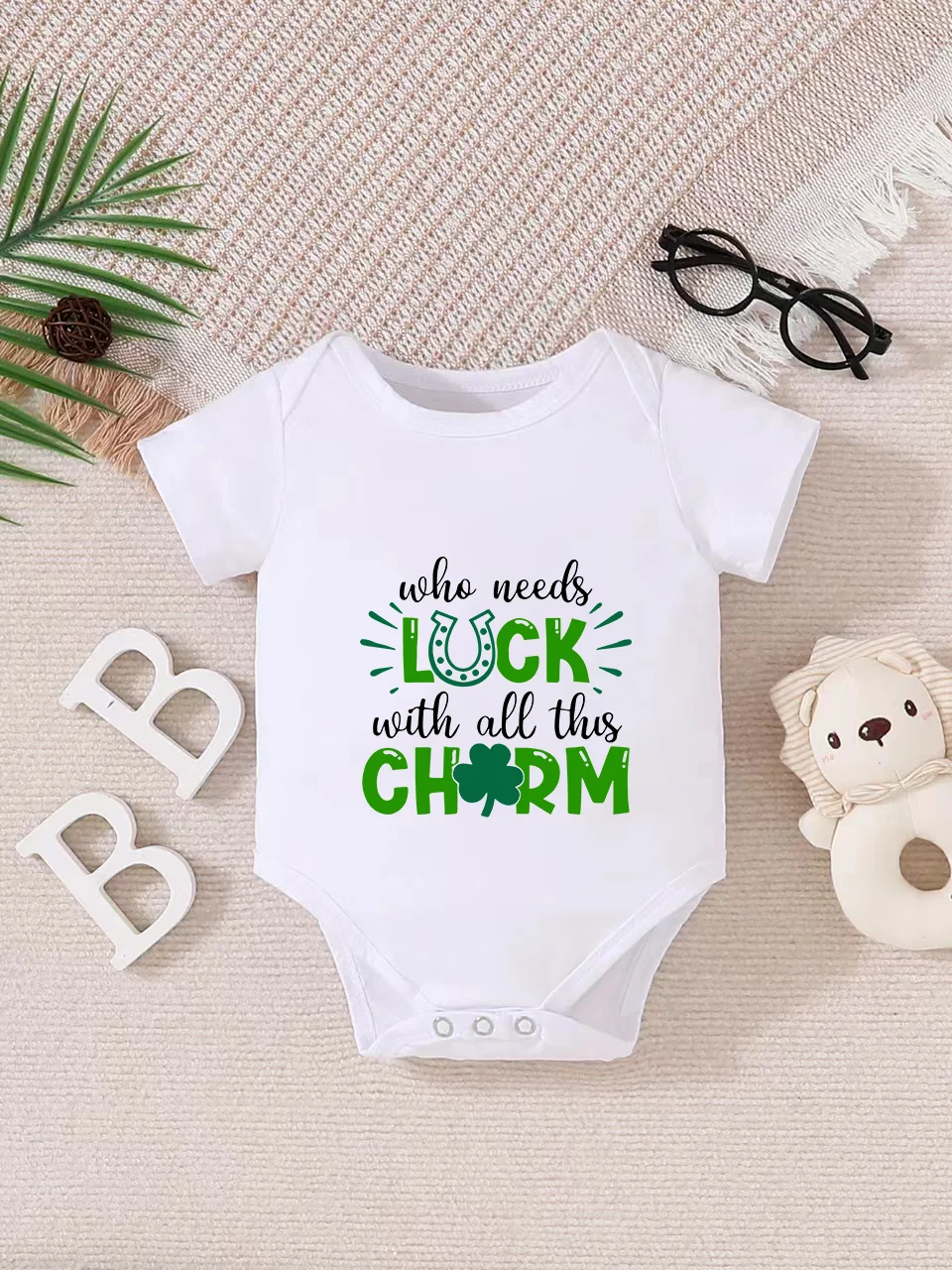 Playful letter-printed baby short-sleeve triangle bodysuit. Button closure for easy dressing, machine washable