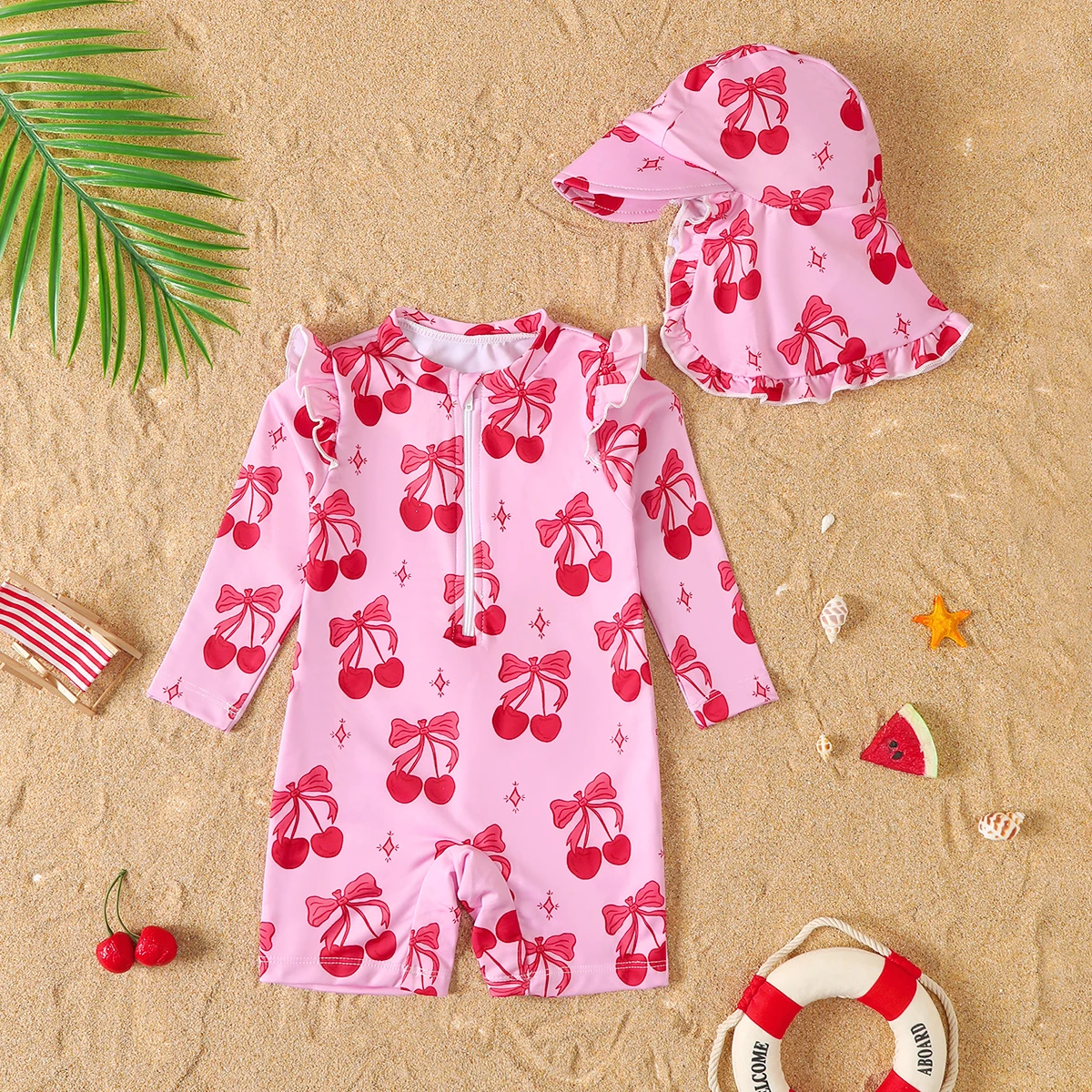 Traje de baño de una pieza con estampado de cerezas y manga larga para bebé niña, con gorro, protección y estilo en una sola pieza.