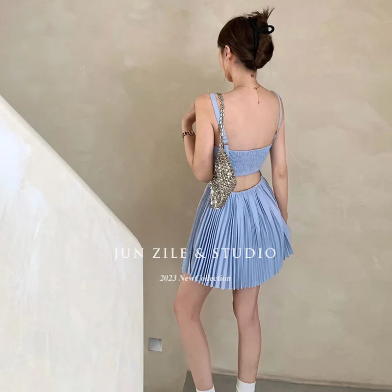 UMI MAO robe printemps haut de gamme sensation exposée dos évidé jupe à bretelles réduisant l'âge jupe plissée femmes jupe courte