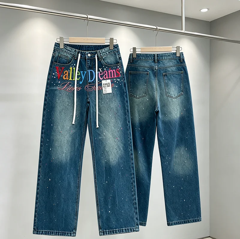 VALLEY Men Women Casual Blue Denim Jeans Front Multi Color Letter Graphic Paint Splatter Detail Wide Leg