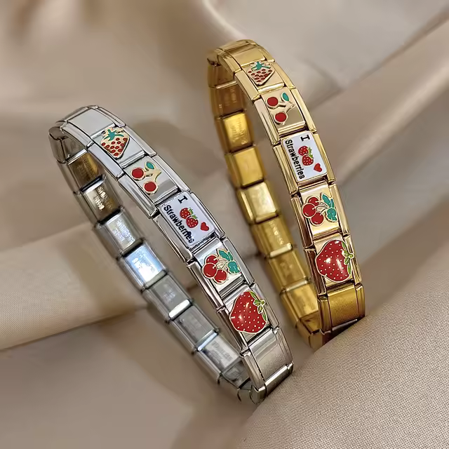 Vintage Italian charm bracelets displayed in soft light showing modular links and enamel designs