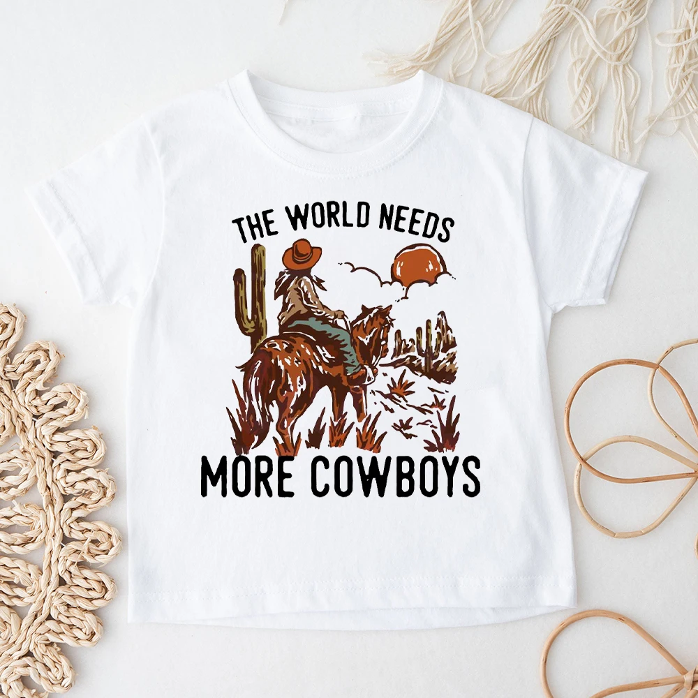 

The World Needs More Cowboys Kids T-Shirt Retro Toddler Short Sleeve Shirt Boys Girls Clothes Vintage Neutral Shirt Kid Gift Tee