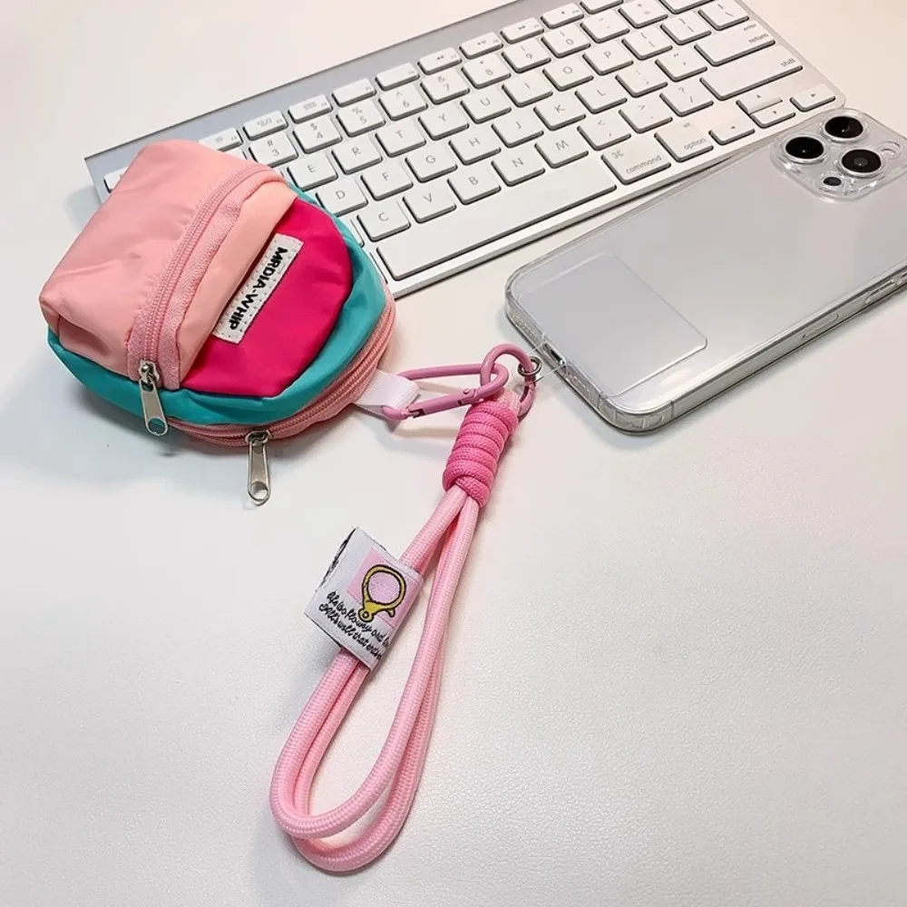 Monedero colgante creativo, correa de muñeca corta antirrobo, bolsa de almacenamiento para auriculares, colgante de Color contrastante, bolsa pequeña para llaves para niña