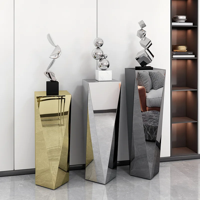 Stainless steel sculpture table next to TV cabinet flower stand Italian light luxury living room floor ornament table