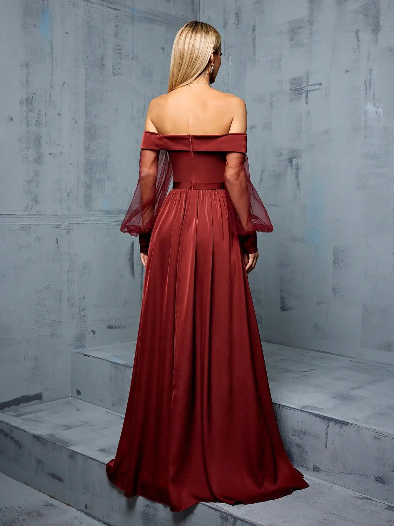 Bridesmaid's floor-length gown with off-shoulder neckline, mesh-satin paneling, and side slit