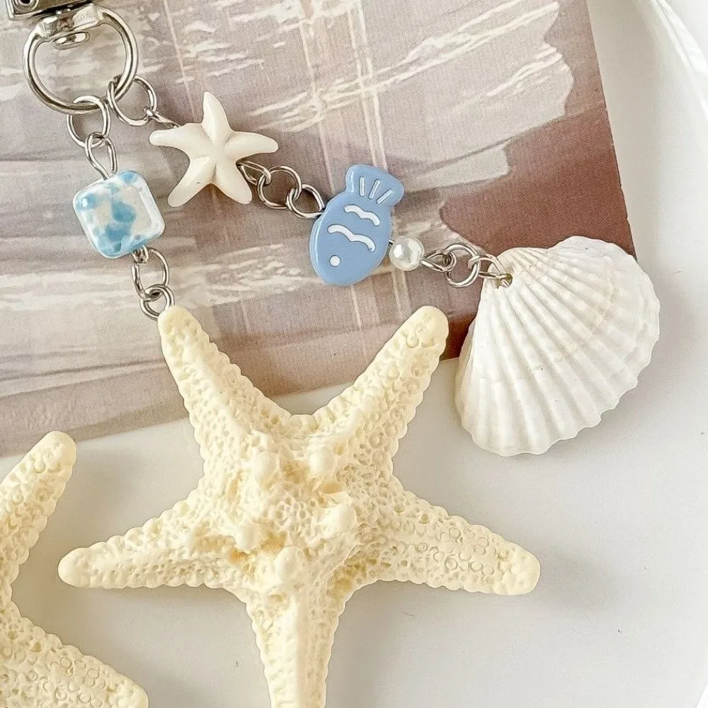 جديد قذيفة الطبيعية نجم البحر قذيفة المفاتيح مزلاج الباب الراتنج حقيبة الحبل نجم البحر الهاتف