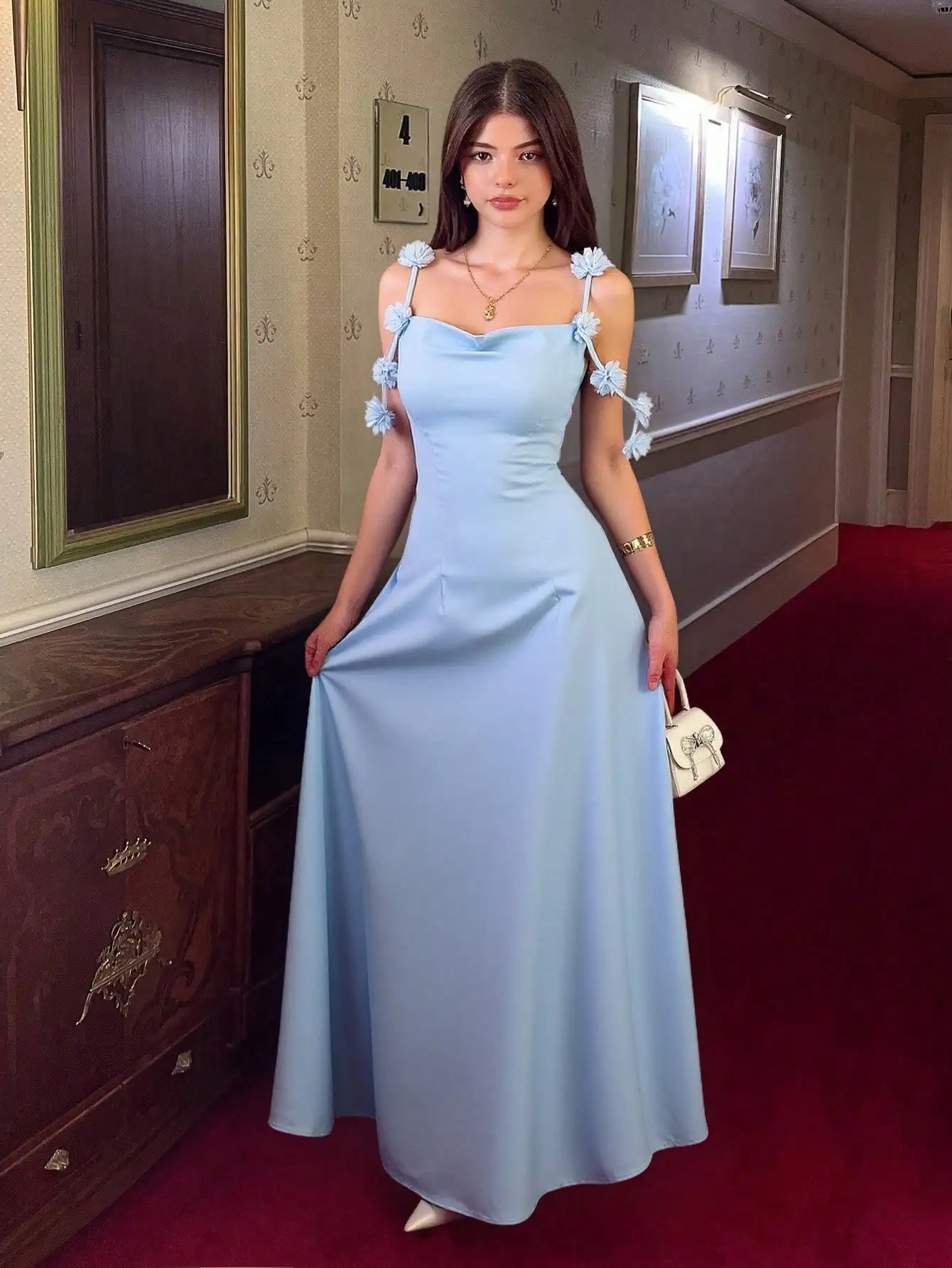 

Светло-голубое атласное платье-комбинация с цветочными деталями на бретелях и вырезом-кауол.