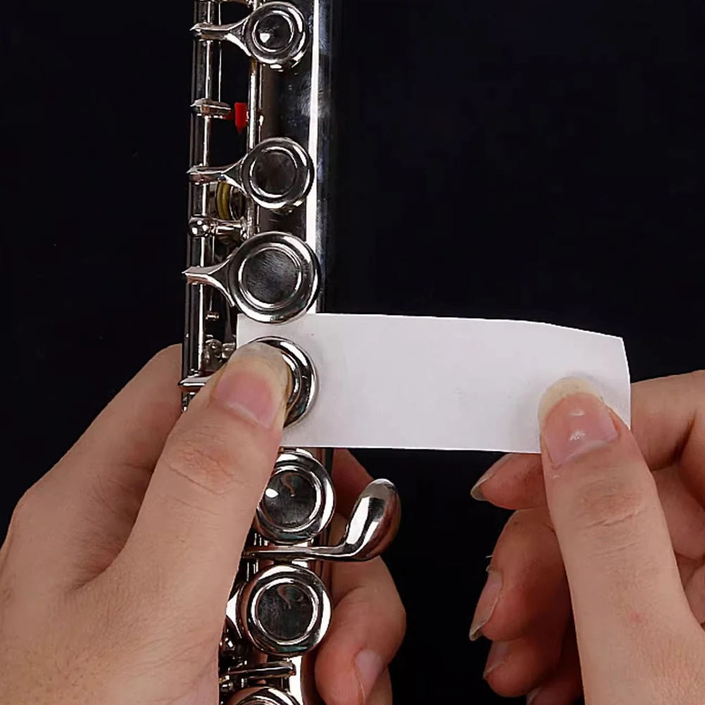 

100Pcs/Box Woodwind Instrument Cleaning Care Paper Anti-Sticky Clarinet Oboe Bassoon Sticky Pad for Saxophone Flute Clarinet