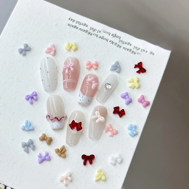 100 ชิ้น Mini Bow ตกแต่งเล็บใหม่ Candy สีเรซิ่นริบบิ้นผสมเครื่องประดับเจาะเล็บอุปกรณ์เสริม