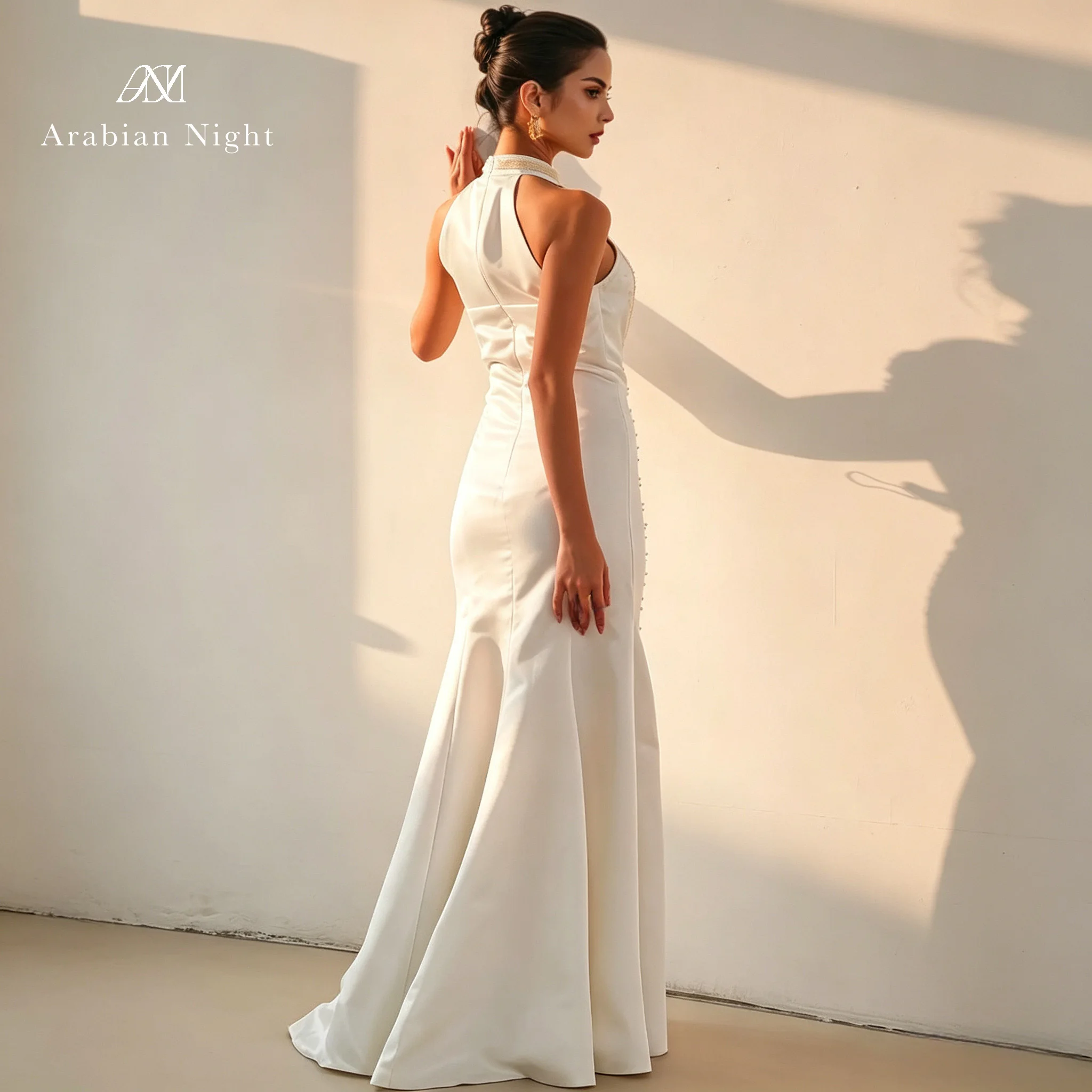Ivory white satin neckless sleeveless fish tail formal evening dress with sequins and pearl beads and pleated frills
