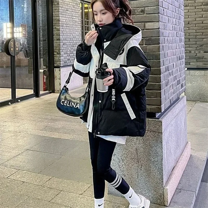 Chaqueta de algodón Parker negra de longitud media para mujer, nueva versión coreana 2026, abrigo con capucha de algodón suelto y empalmado, cálido para invierno.