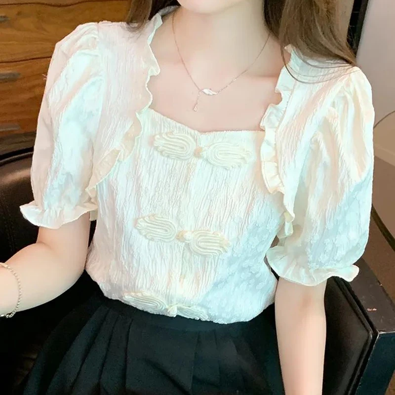 White shirt women's summer design retro buckle wood ear collar shirt chic versatile waist bubble sleeve top.