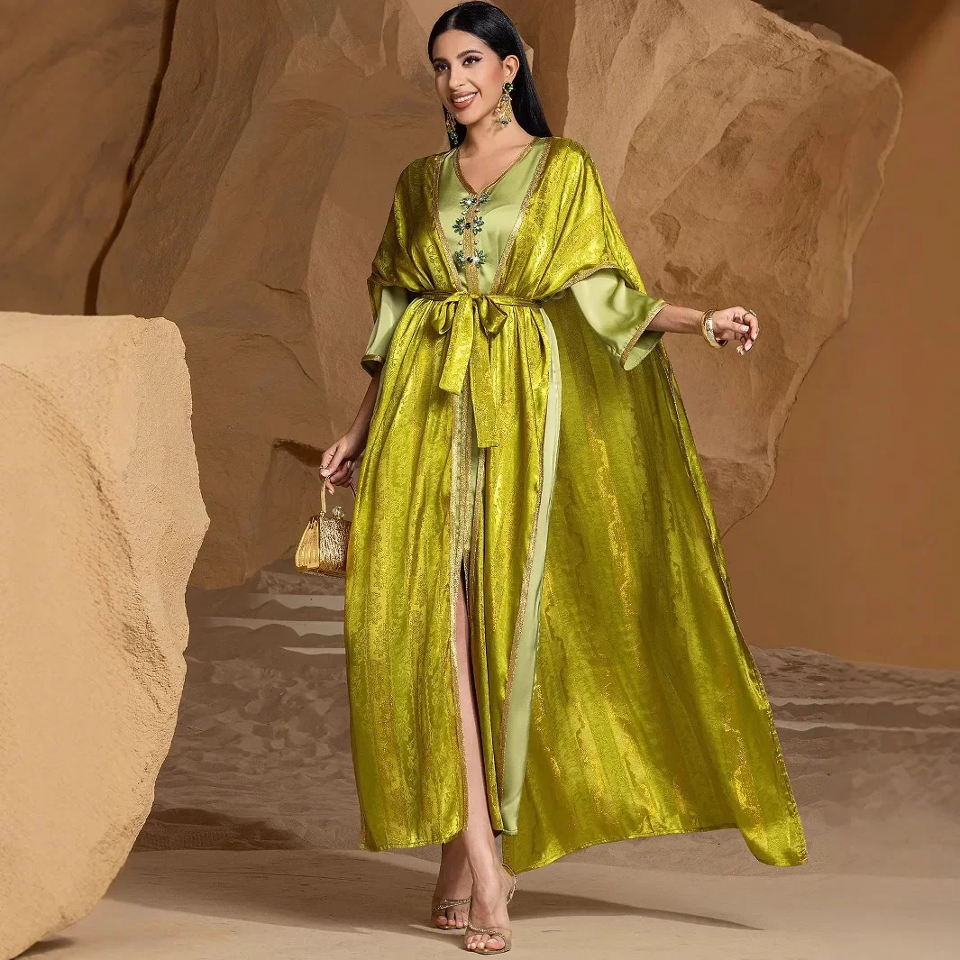 A new heavy-workmanship gold-embroidered party dress from Dubai, the Middle East. It is a two-piece abaya-style dress for ladies