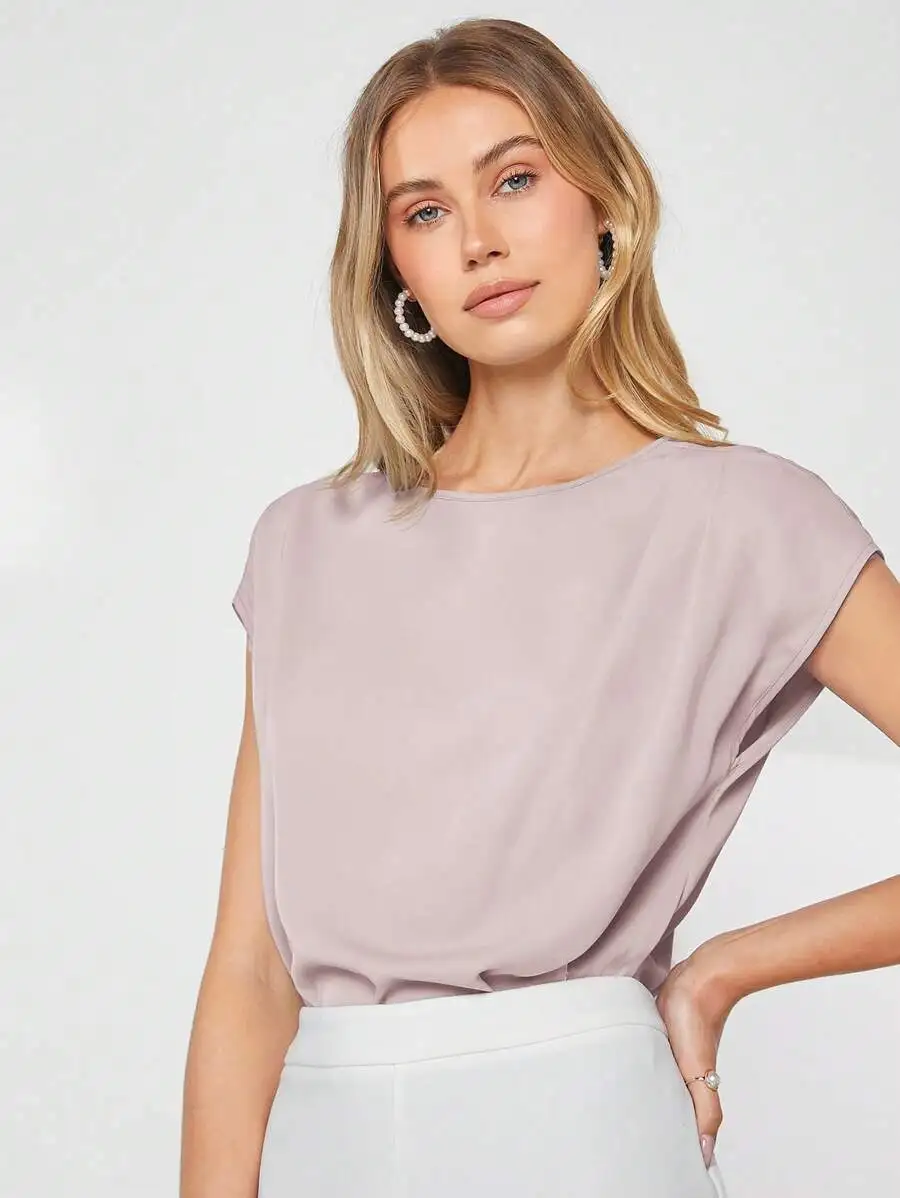 

Elegant Solid Pastel Blouse With Batwing Sleeves And Asymmetrical Hem For Professional Office Or Teaching Wear