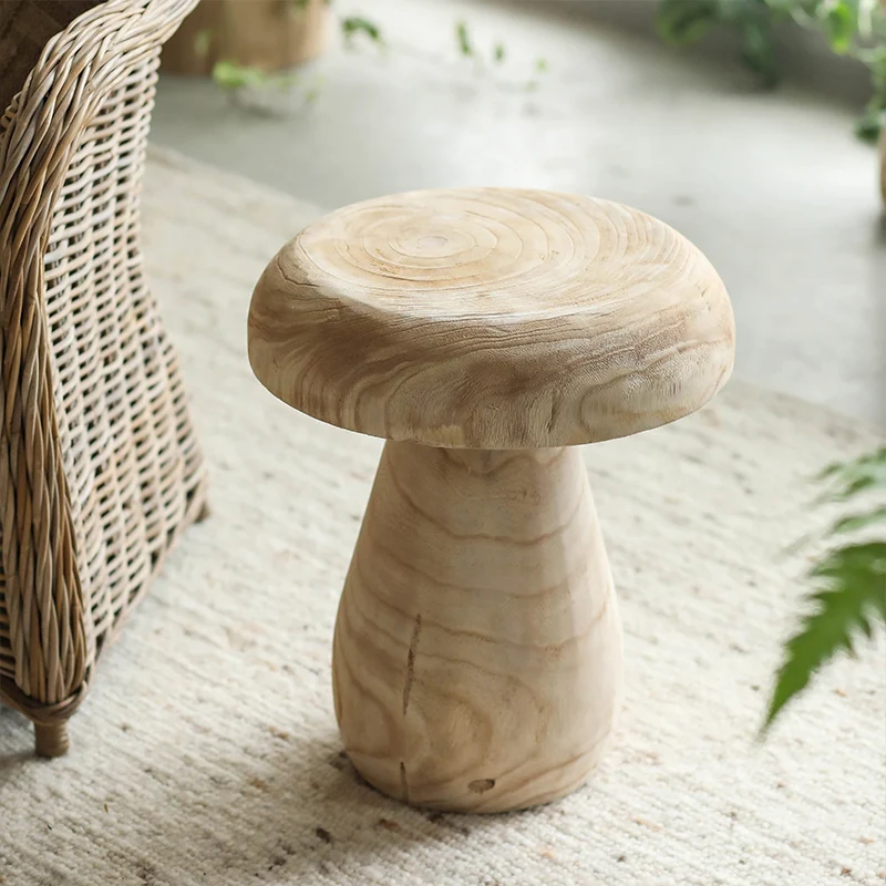 A few solid wood paulownia retro living room floor decoration mini coffee table beside the mushroom stool sofa.