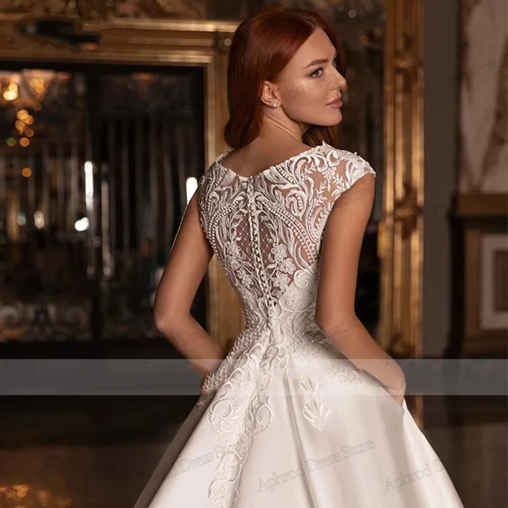 Robes De mariée glamour une ligne Robes De mariée en Satin dentelle Appliques sans manches Robes gracieuses robes De Novia personnalisées 2026