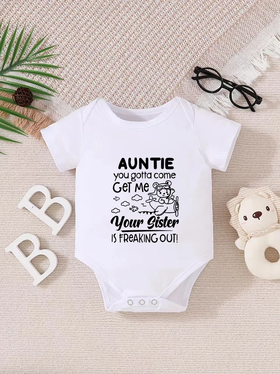 Playful letter-printed baby short-sleeve triangle bodysuit. Button closure for easy dressing, machine washable